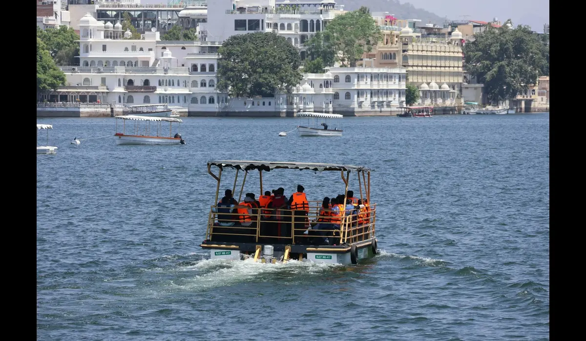 Boat cruising on Lake Pichola during golden hour