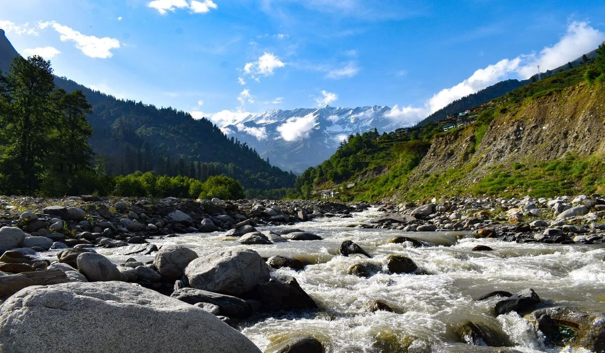Manali valley in September with green hills Beas river and snow capped Himalayan peaks